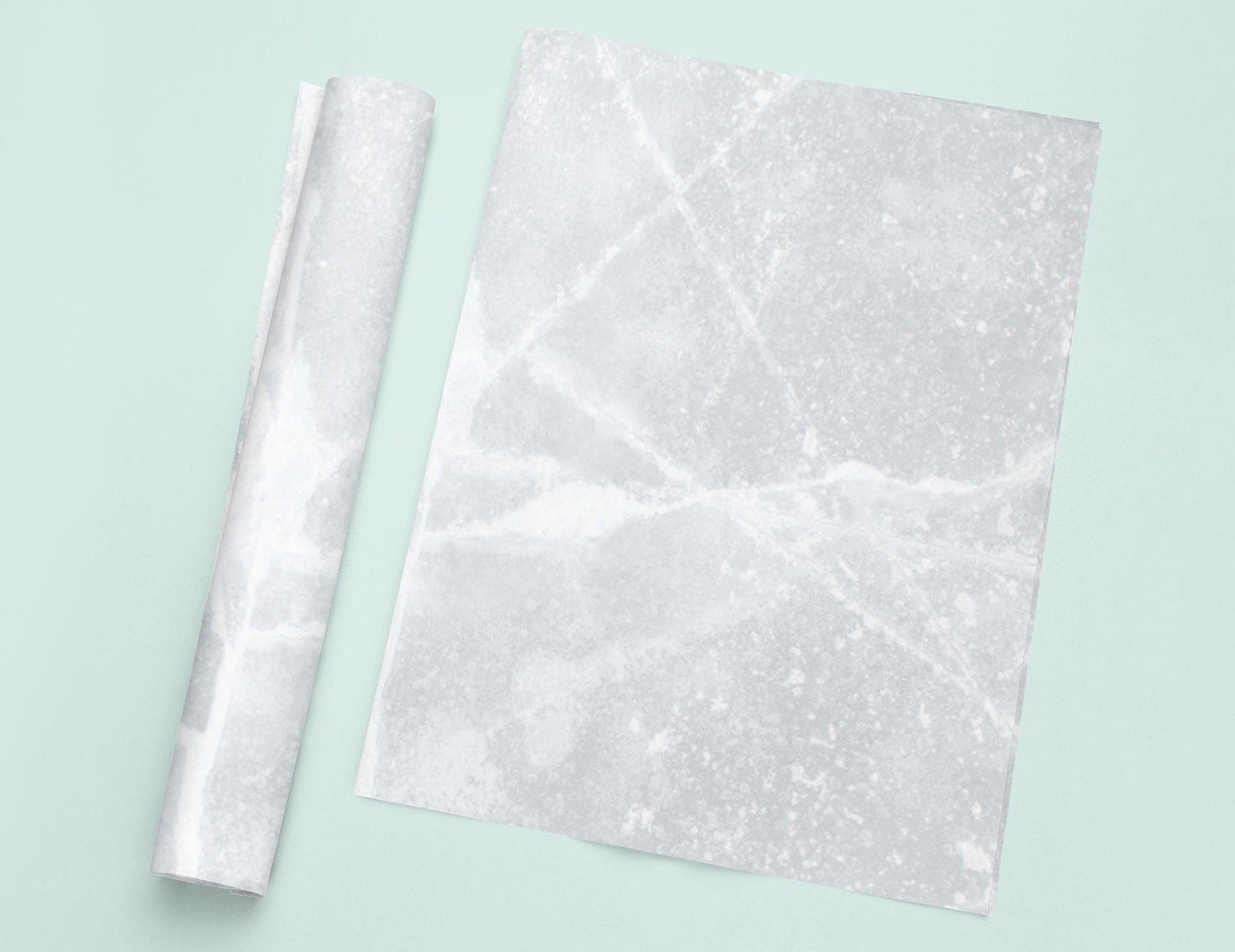 a piece of white marble next to a roll of paper