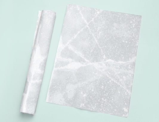 a piece of white marble next to a roll of paper