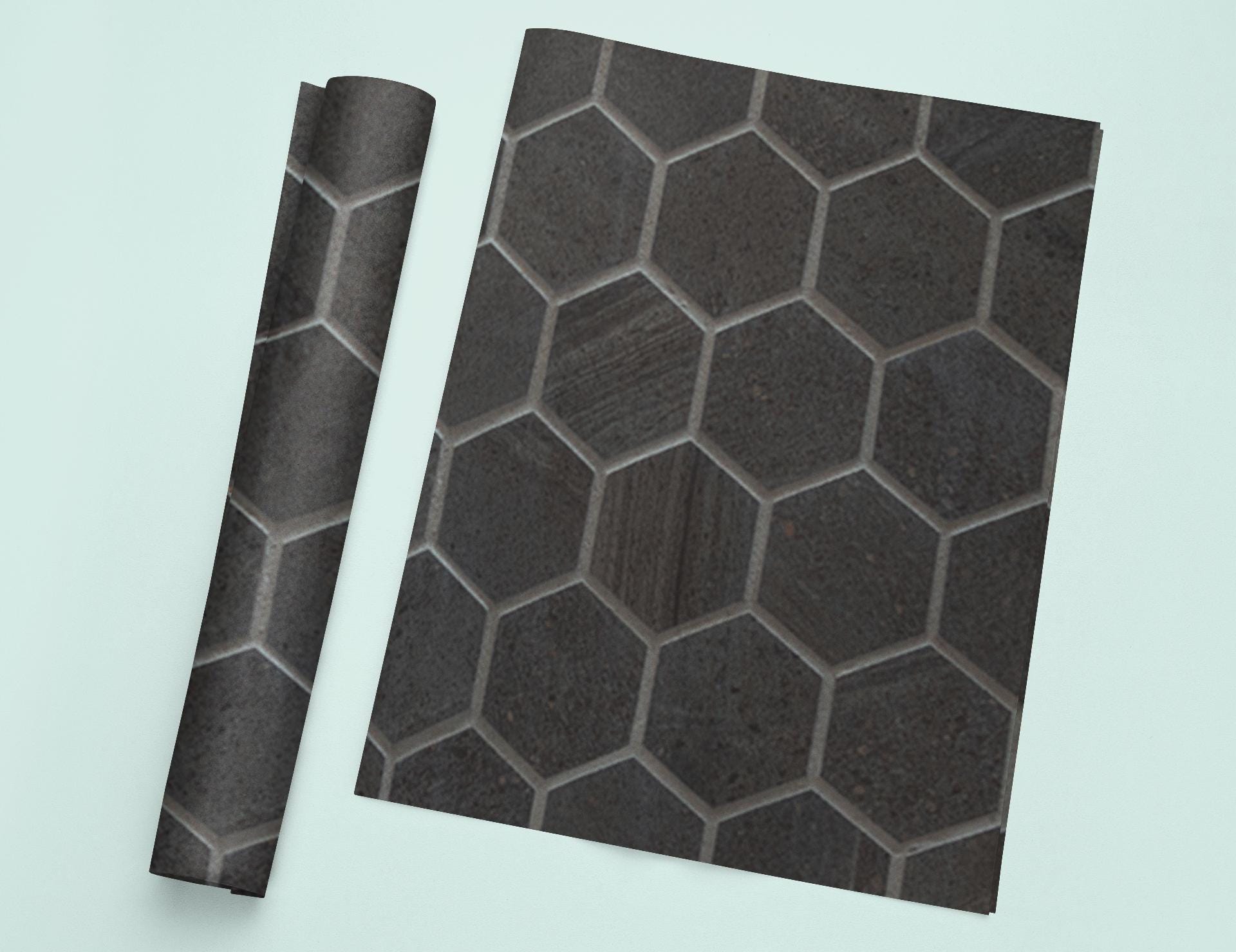 a piece of black tile sitting on top of a white table