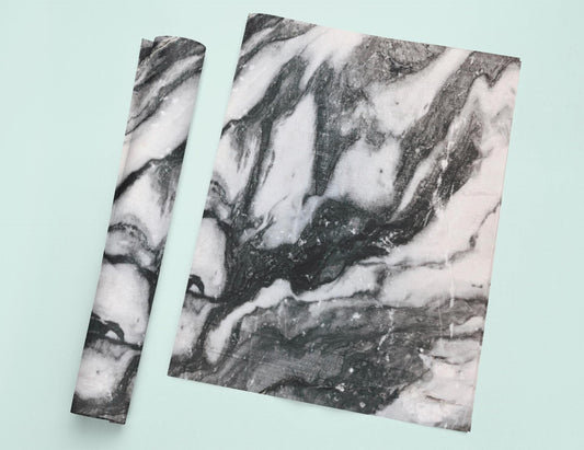 two pieces of paper with a black and white marble pattern