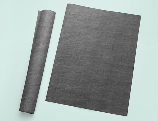 a roll of black paper sitting on top of a table