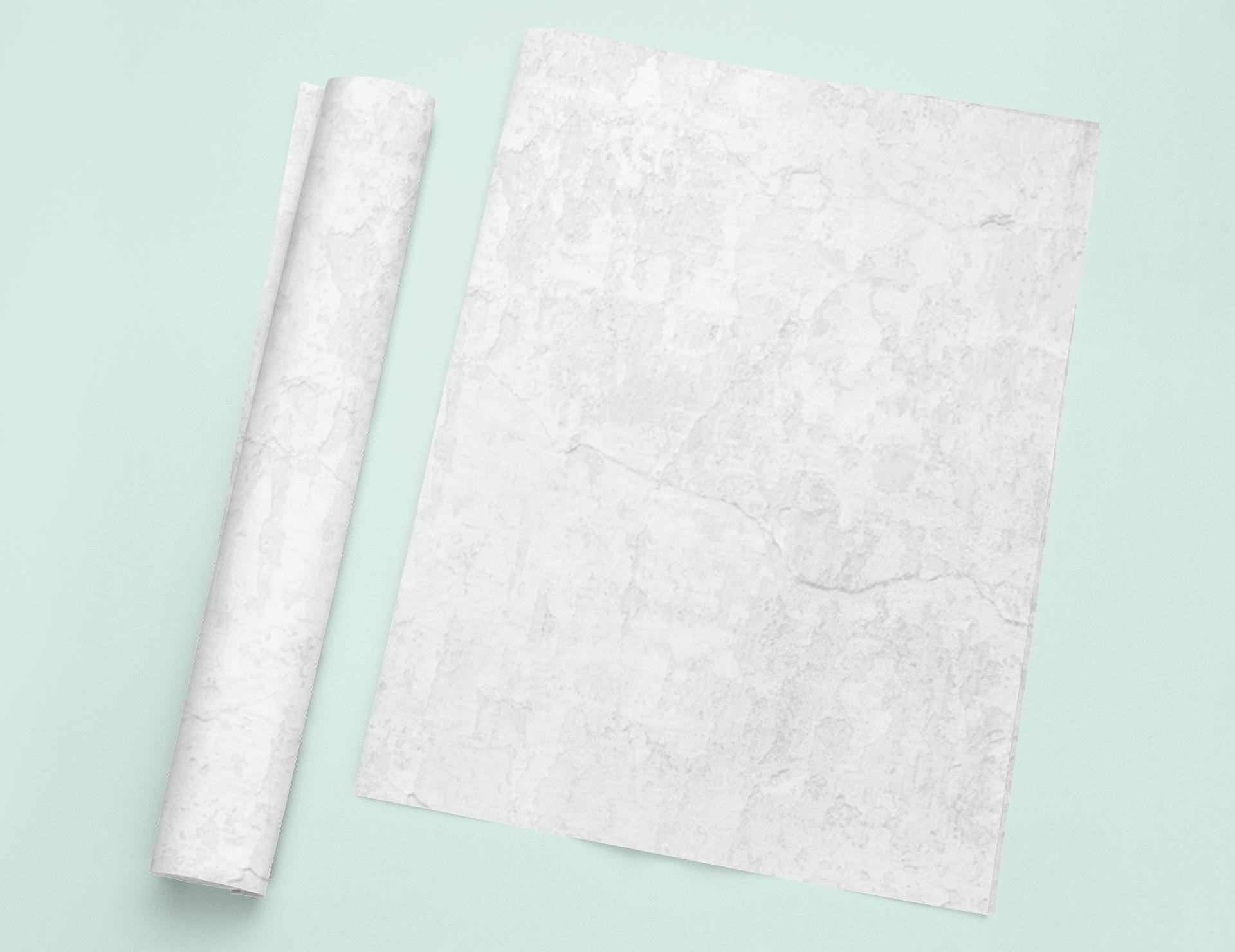 a piece of white paper next to a roll of white paper