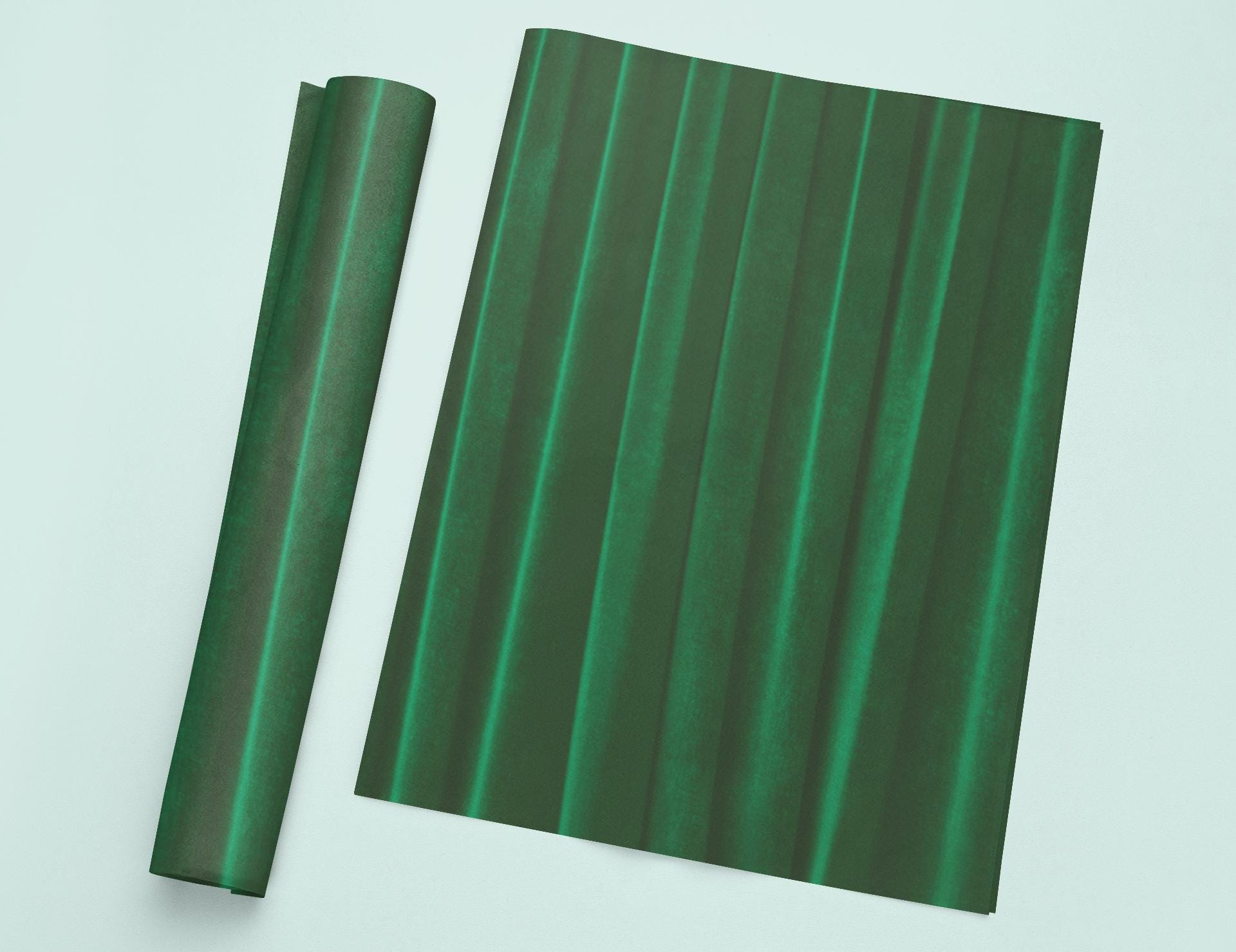 a roll of green paper next to a roll of green paper