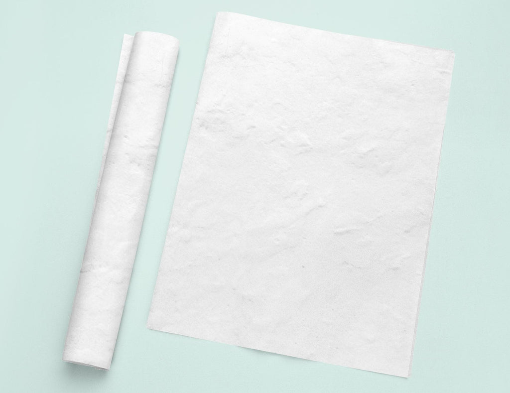 a piece of white paper next to a roll of white paper