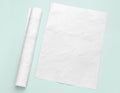 a piece of white paper next to a roll of white paper