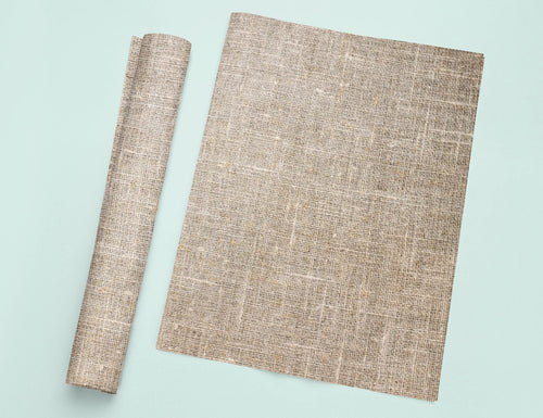 a piece of cloth next to a roll of paper