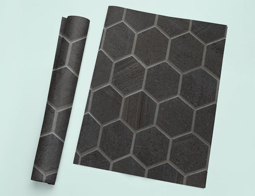 a piece of black tile sitting on top of a white table
