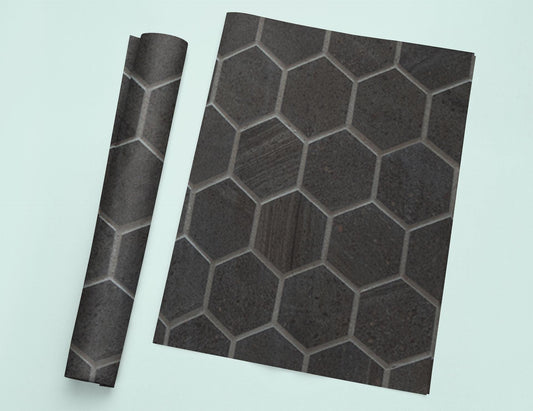 a piece of black tile sitting on top of a white table