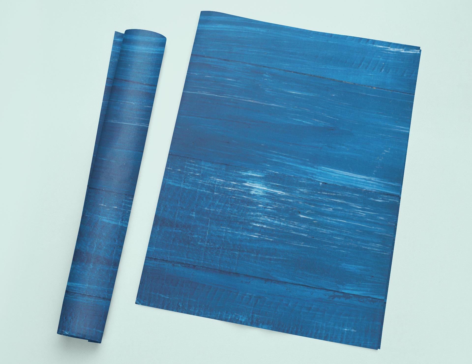 a blue piece of paper sitting on top of a white table