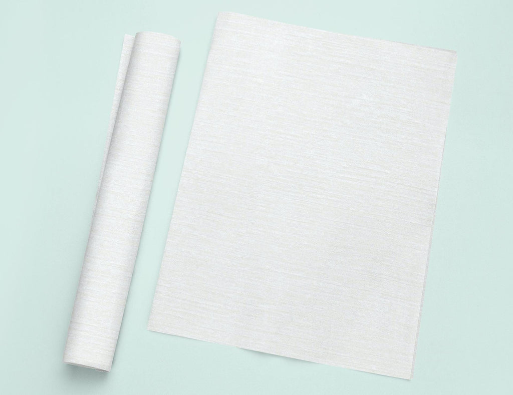 a roll of white paper next to a roll of white paper