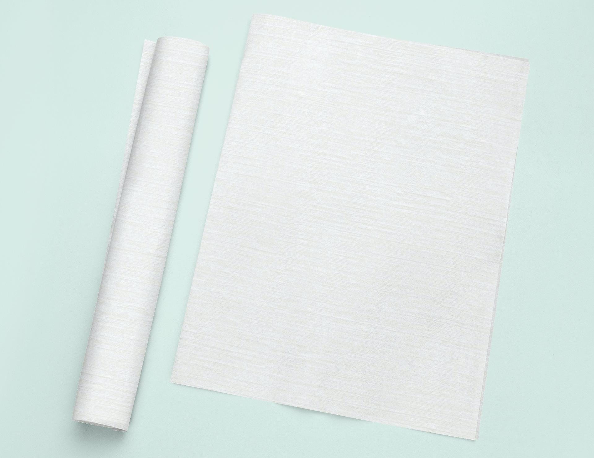 a roll of white paper next to a roll of white paper