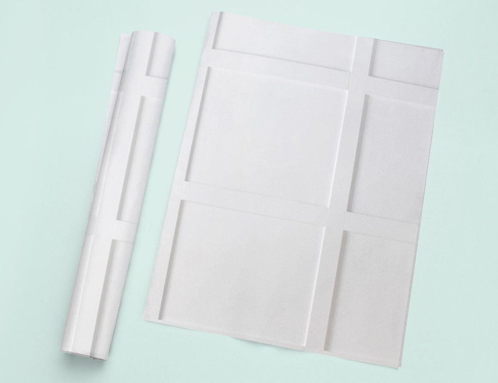 a piece of white paper next to a roll of white paper