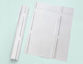 a piece of white paper next to a roll of white paper