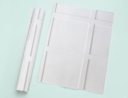 a piece of white paper next to a roll of white paper