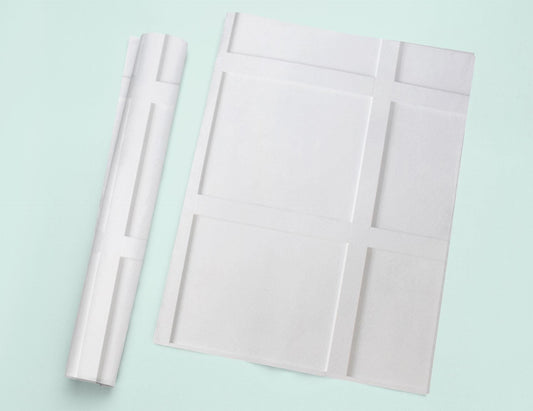 a piece of white paper next to a roll of white paper