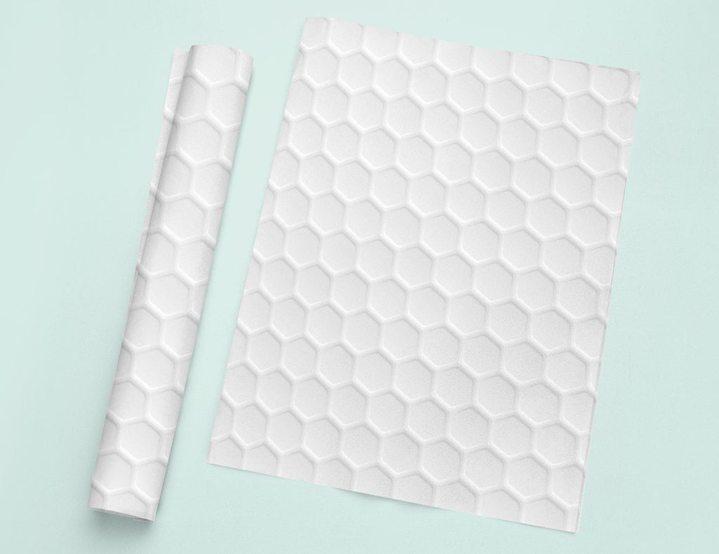 a piece of white paper next to a roll of white paper