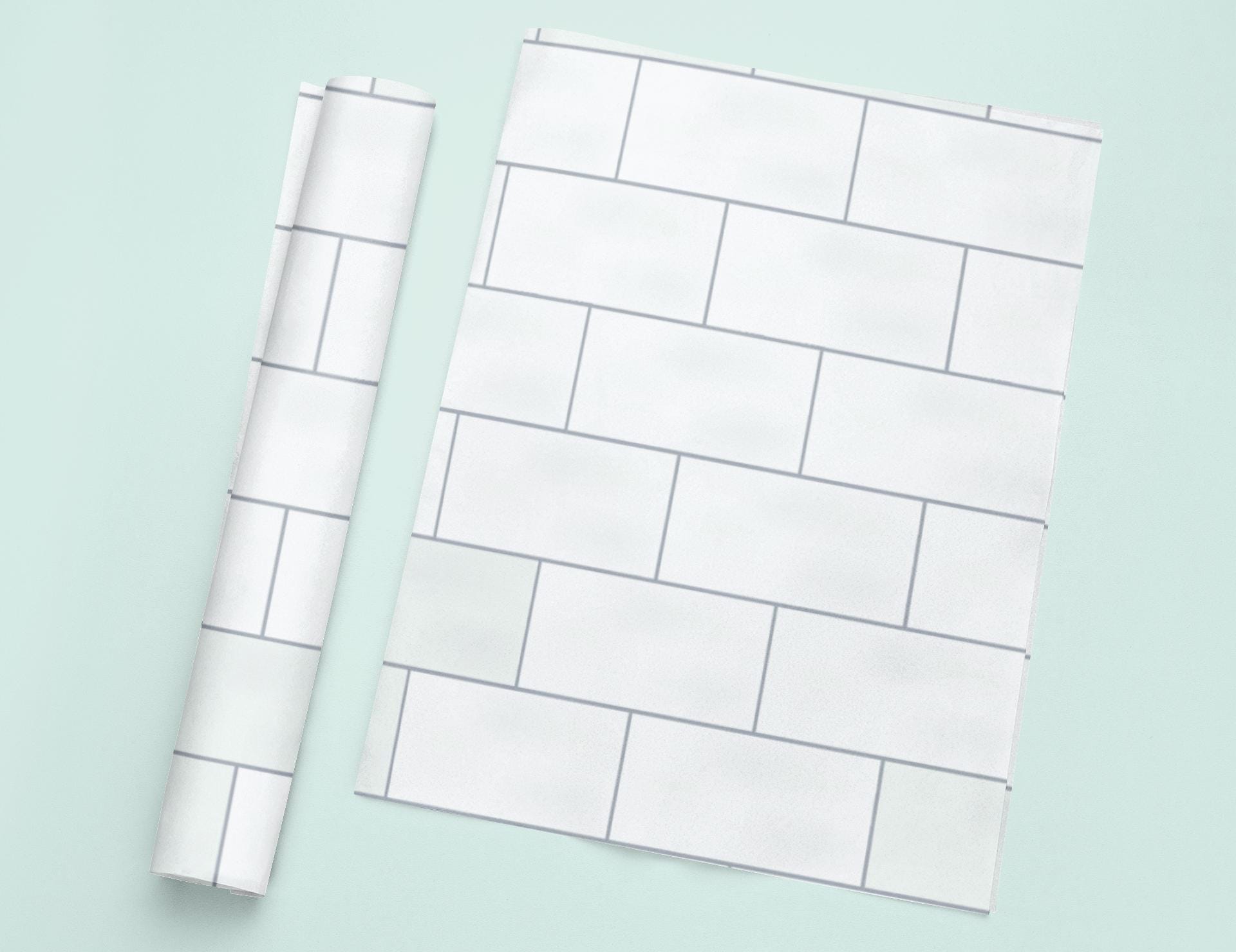 a piece of white paper next to a roll of white paper