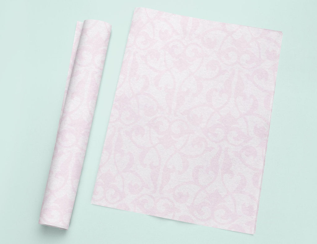 a roll of pink tissue next to a roll of pink tissue