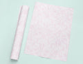 a roll of pink tissue next to a roll of pink tissue