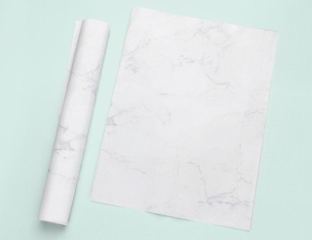 a roll of white paper next to a roll of white paper