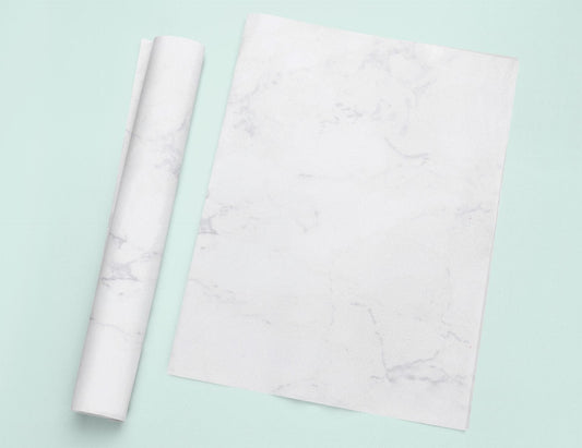 a roll of white paper next to a roll of white paper