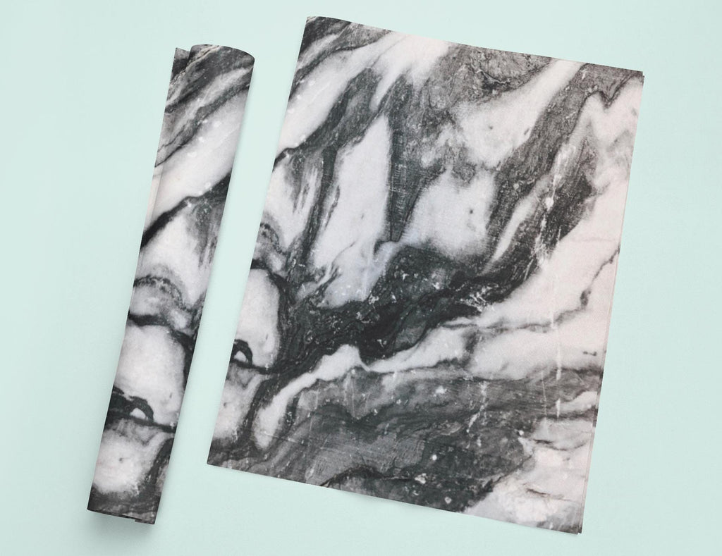 two pieces of paper with a black and white marble pattern