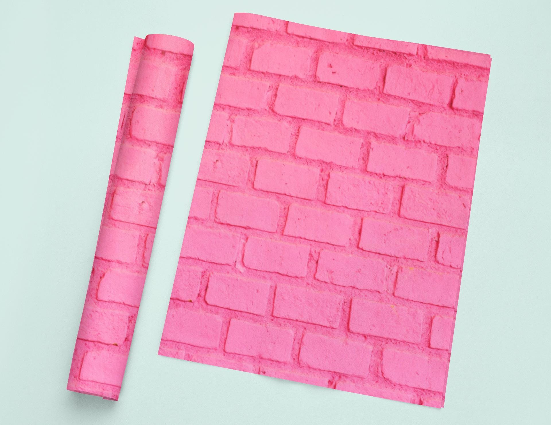 a piece of pink paper next to a pink brick wall