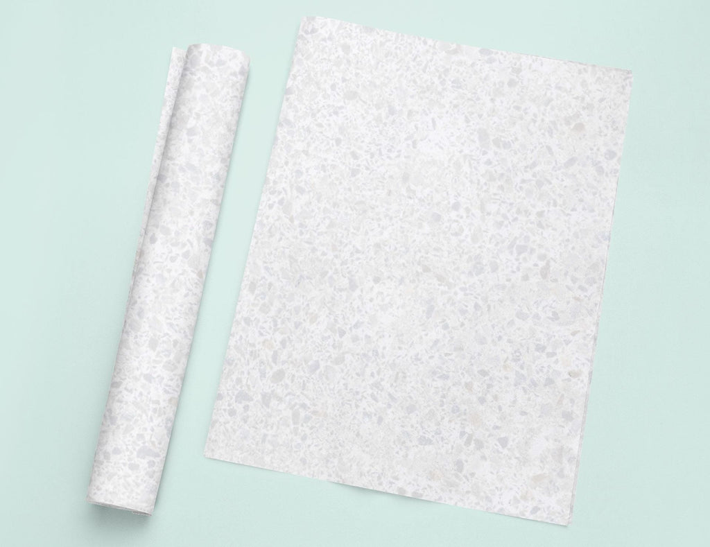 a piece of paper sitting on top of a table next to a roll of paper
