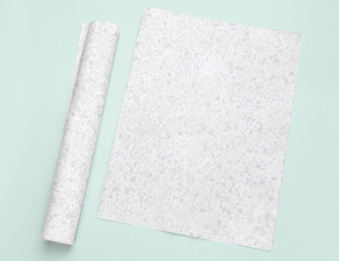 a piece of paper sitting on top of a table next to a roll of paper