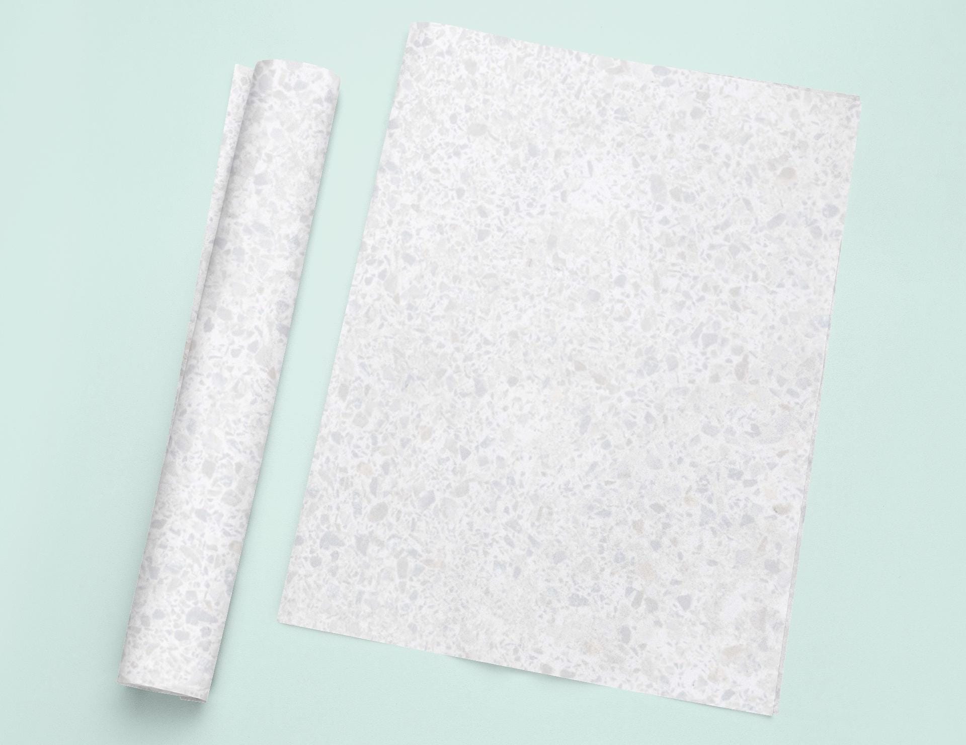 a piece of paper sitting on top of a table next to a roll of paper