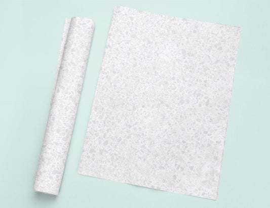 a piece of paper sitting on top of a table next to a roll of paper