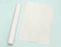 a roll of white paper next to a roll of white paper