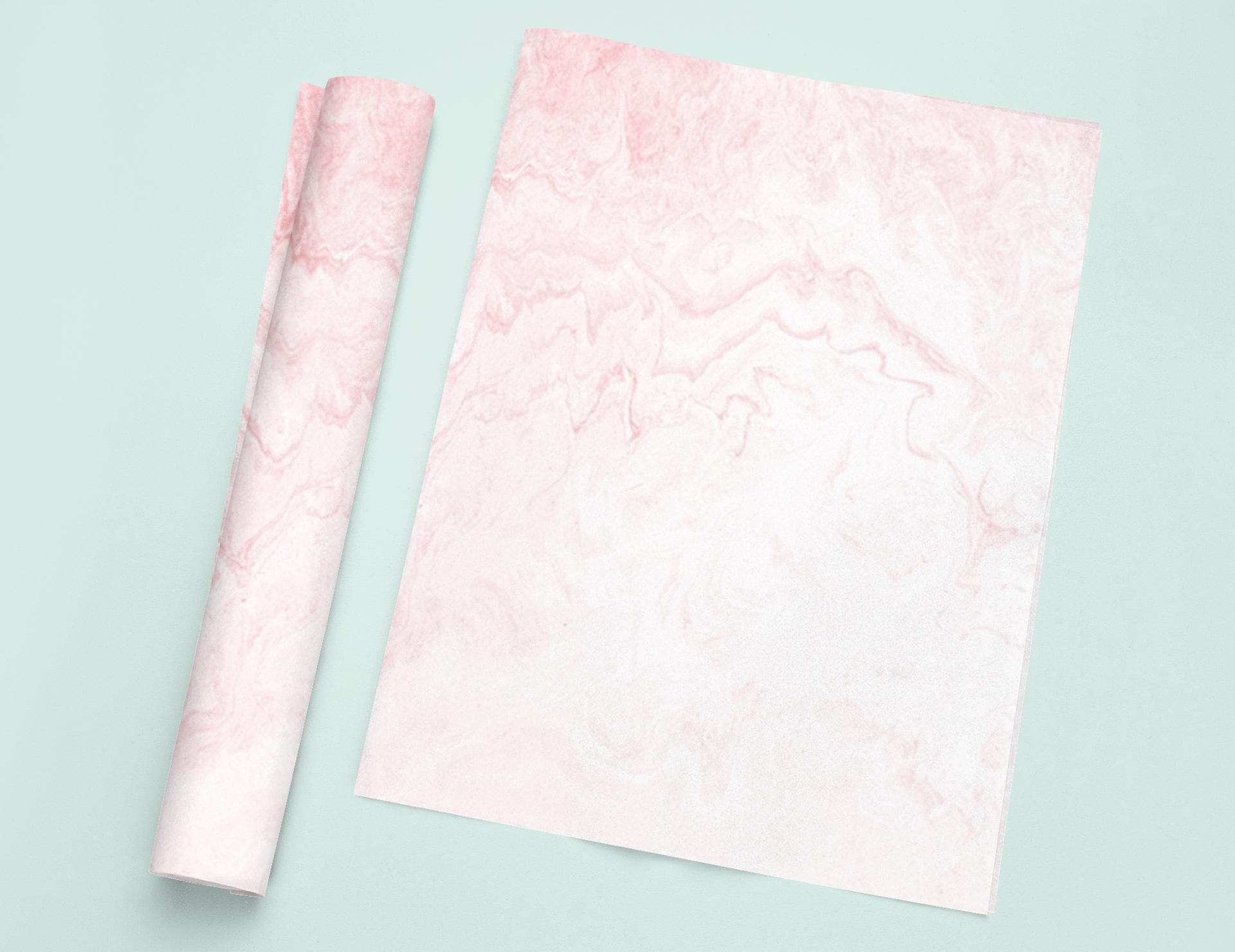 a roll of pink marble paper next to a roll of pink marble paper