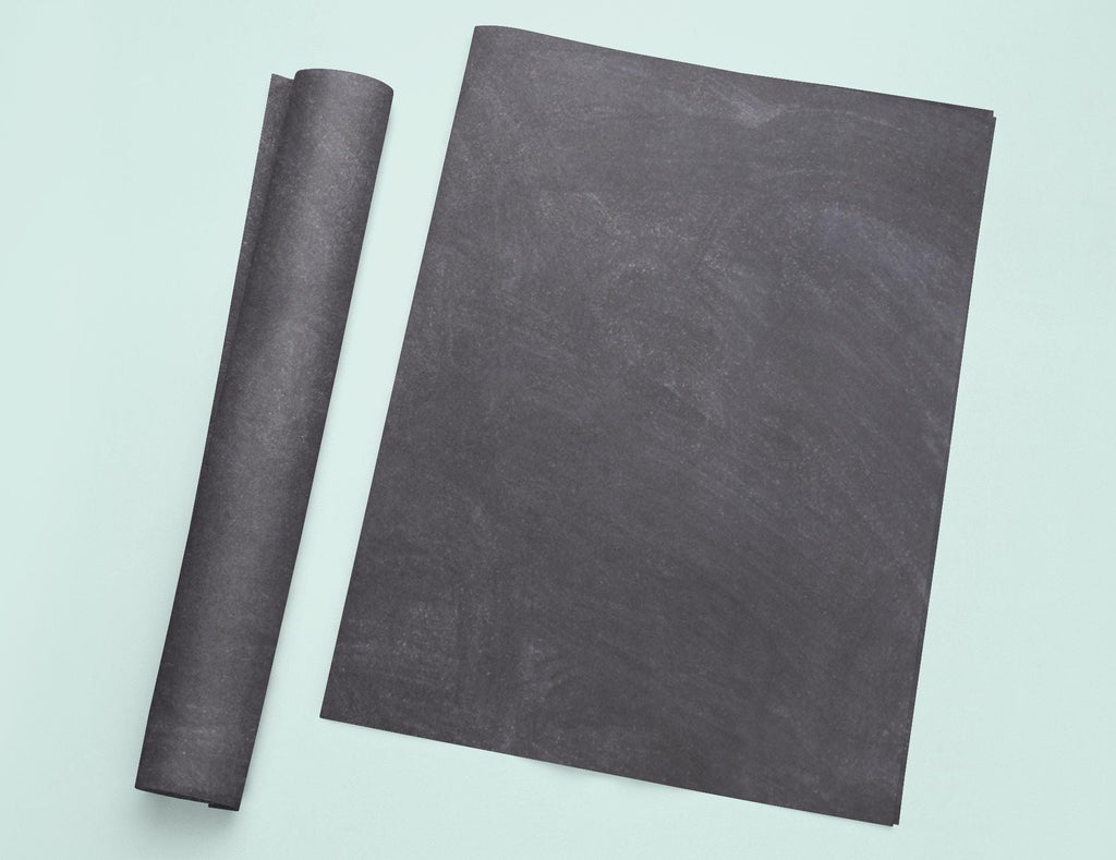 a piece of black paper next to a roll of black paper