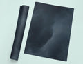 a picture of a black cloud with a roll of black paper next to it