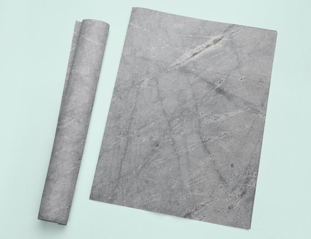 a piece of marble next to a roll of paper