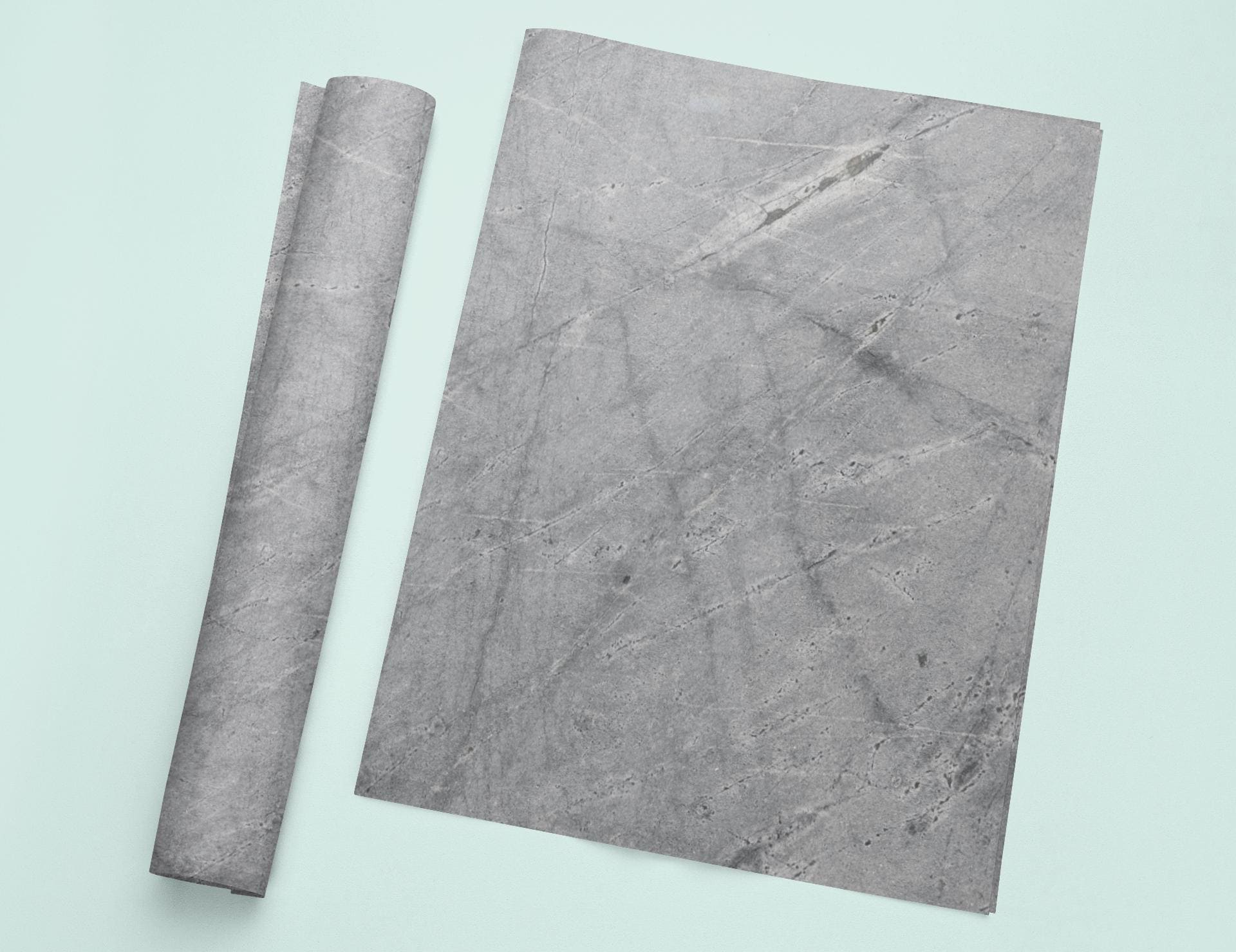 a piece of marble next to a roll of paper