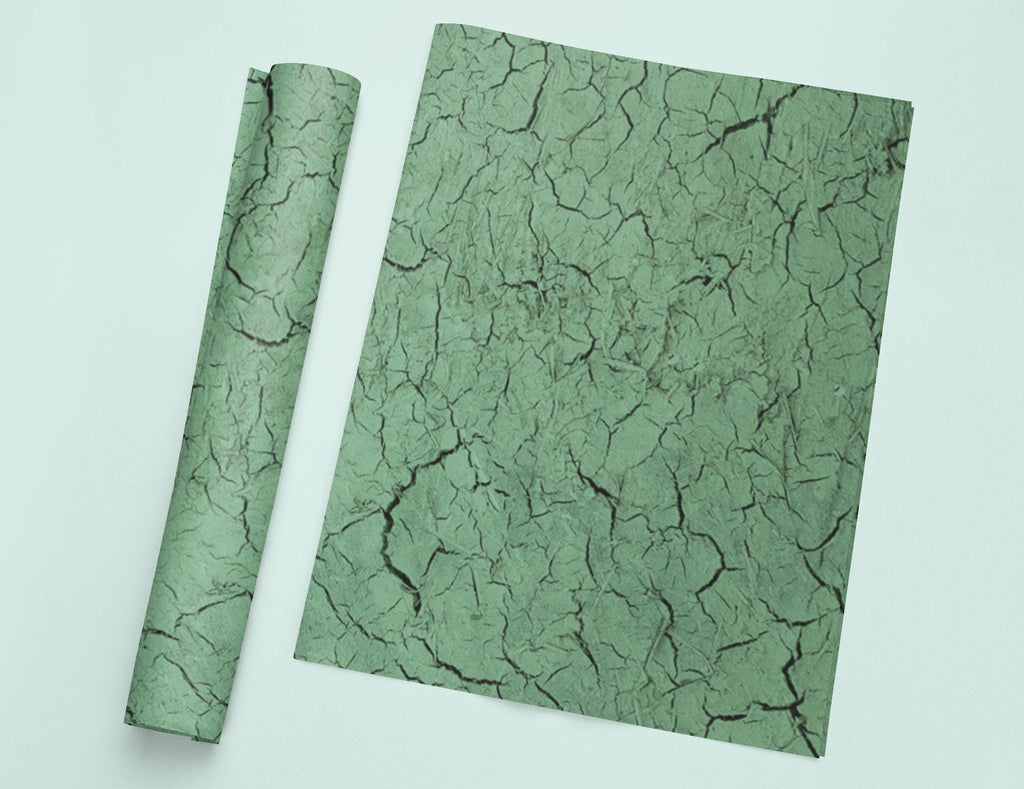 a piece of green paper with a crack in it