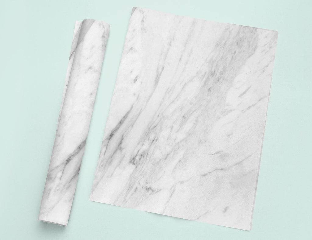 a pair of scissors sitting on top of a marble paper